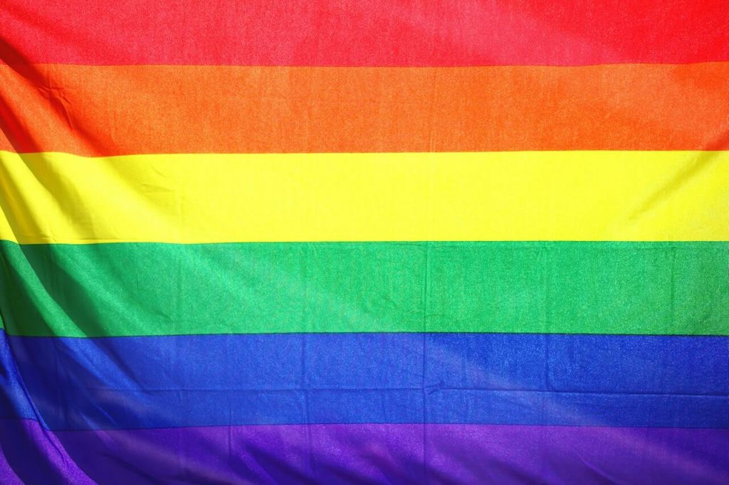 Image of a rainbow flag, a symbol of LGBTQ+ pride and diversity. 